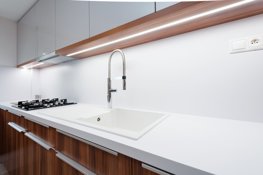 Sink with tap on white worktop in contemporary kitchen